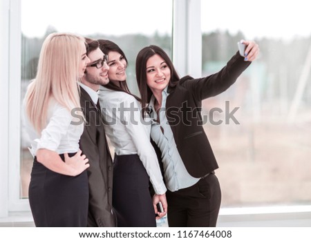 successful business team is doing a selfie in the lobby of the modern office