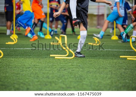 Soccer ball tactics on grass field with cone for  training children jump skill in Soccer academy