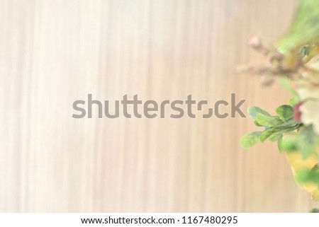 Blurry background flower and wood flooring blurred, Enter text