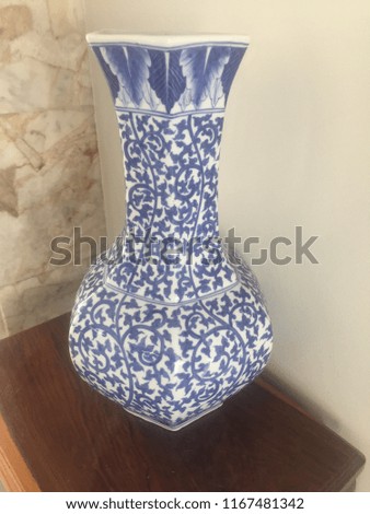 The vase is a tribal sculpture that uses fine artwork.