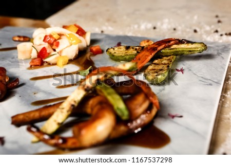 Grilled octopus on white plate. Greek dish