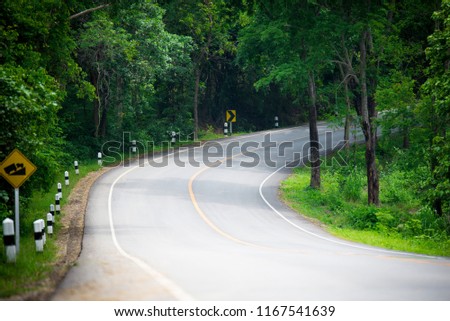 country asphalt road with curves in rural thailand
