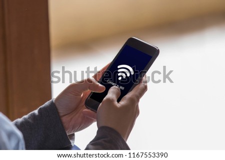 Connect to wi-fi concept. Hands holding smartphone with wi-fi connection on the screen.