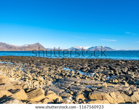 Large stones at Akranes peninsula near the lighthouses under blue sky, Iceland