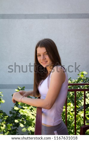Beautiful teenage girl posing. On terrace