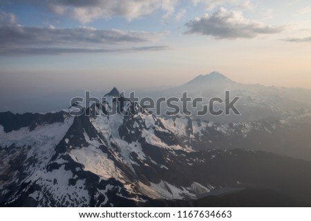 Aerial landscape view of the rugged mountain peaks with Mount Baker in the background. Located Northeast of Seattle, Washington, United States of America.