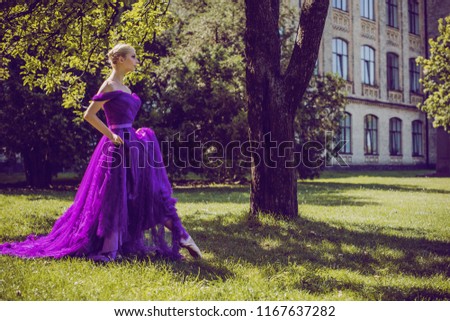Young Ballerina in vintage look. Ballet Dancer Girl. Image of a Dancing Woman. Lady in purple evening dress demonstrated femininity. Classical Choreography Style