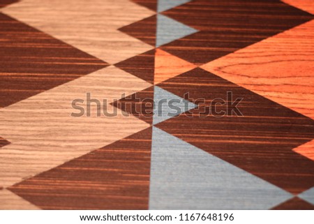 Classical wooden parquet design, geometric pattern with triangles and squares. Background photo texture.