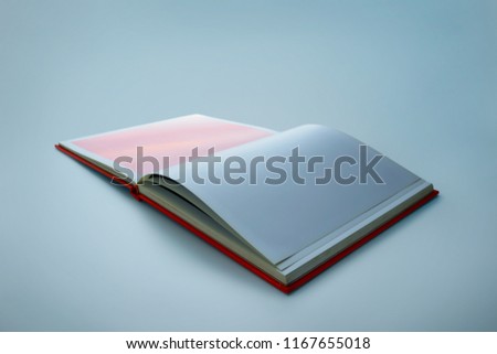 Opened blank square book isolated on blue backgroung .