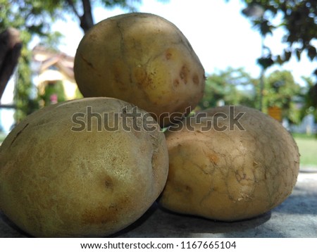 Closeup of stack of ordinary potatoes before being peeled, the picture is taken with selective focus
