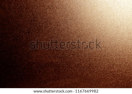 Ground glass texture in brown with light in corner. abstract background and pattern for designers.