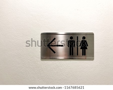 Restroom sign on the wall.