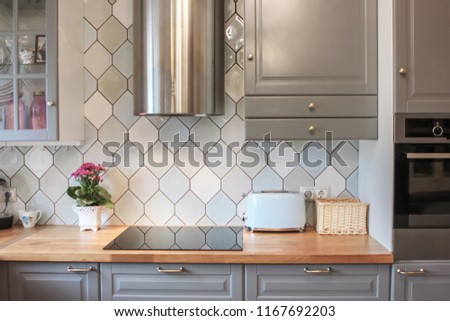 Kitchen interior in grey colors stove refrigerator chairs, classic style