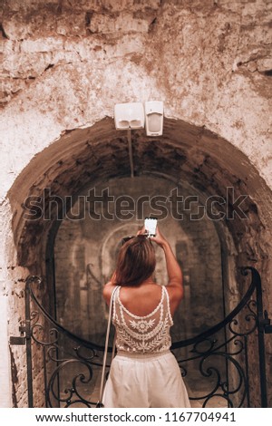Woman taking a picture in Orval Abbey