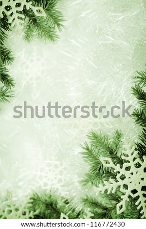 Christmas background made of spruce branch and snowflakes