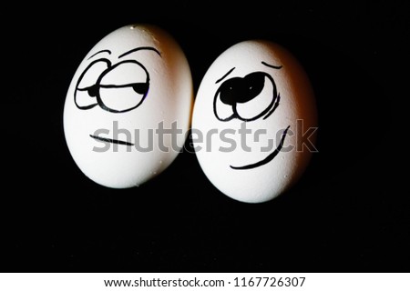 egg on a black background,emotion
