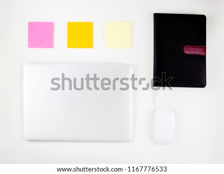 Top view of laptop computer with open display screen monitor on desk office, mouse and notepad and note isolated on white background, business and communication technology concept.