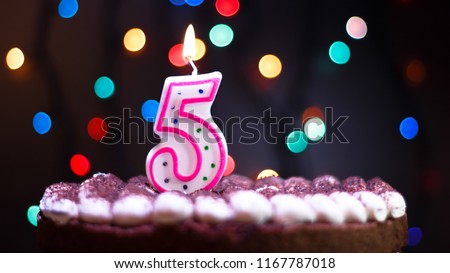 Happy Birthday.Holiday cake with candles.Birthday greetings.Greeting card.Colorful birthday candles.Five years.Growing up.Abstract colorful background.Colorful bokeh.Top view.Stop motion. Royalty-Free Stock Photo #1167787018