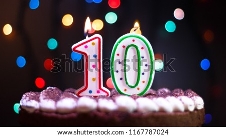 Happy Birthday.Holiday cake with candles.Birthday greetings.Greeting card.Colorful birthday candles.Ten years.Growing up.Abstract colorful background.Colorful bokeh.Top view.Stop motion. Royalty-Free Stock Photo #1167787024