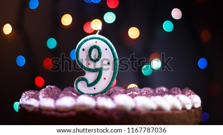 Happy Birthday.Holiday cake with candles.Birthday greetings.Greeting card.Colorful birthday candles.Nine years.Growing up.Abstract colorful background.Colorful bokeh.Top view.Stop motion.