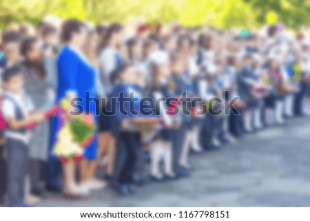 blurred abstract background image with students and teachers at the school meeting on the day of knowledge September 1