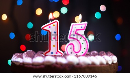 Happy Birthday.Holiday cake with candles.Birthday greetings.Greeting card.Colorful birthday candles.Fifteen years.Growing up.Abstract colorful background.Colorful bokeh.Top view.Stop motion. Royalty-Free Stock Photo #1167809146