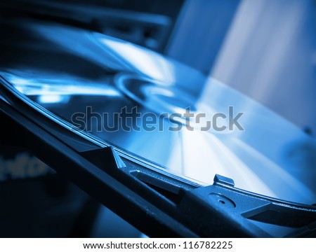 Disk in dvd-rom in blue colors Royalty-Free Stock Photo #116782225