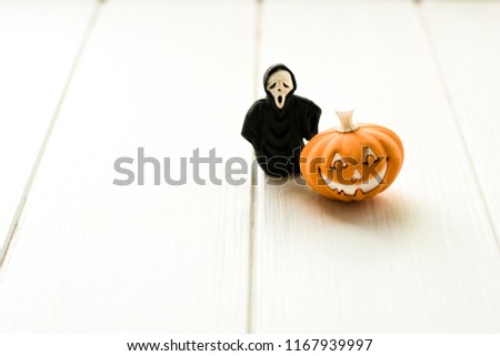 Halloween holiday background with a puppkin. Pumpkin with a funny face. Happy Halloween.