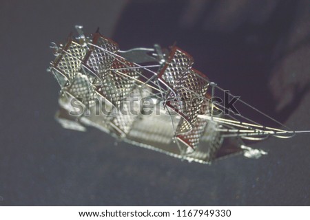 ship on a black background, metal ship figure