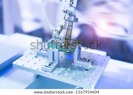 soldering iron tips of robotic system for automatic point soldering for printed and assembly electric circuit board ( PCB ) at factory Royalty-Free Stock Photo #1167954604