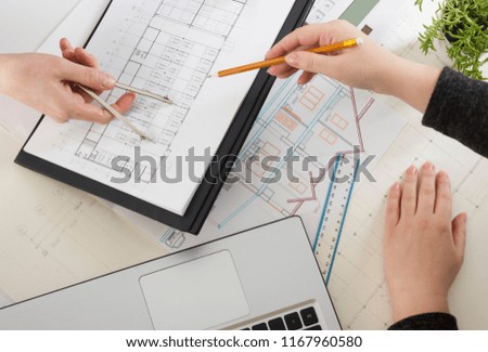 Architects working on blueprint, real estate project. Architect workplace - architectural project, blueprints, ruler, calculator, laptop and divider compass. Construction concept. Engineering tools.