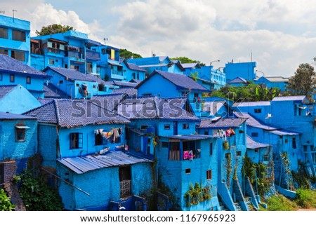 Panoramic view of village with old houses painted in blue color. Popular place to visit for city tour on family holidays. Travel destination in Malang, East Java, Indonesia