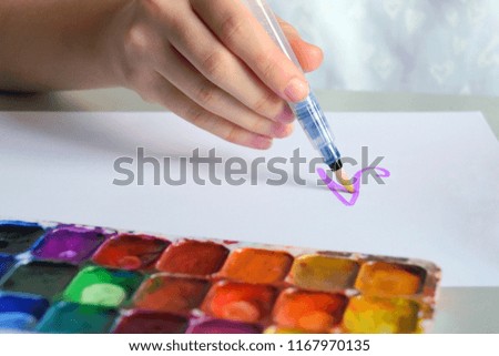 Teenager girl lettering alphabet with colorful paints palette on front