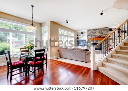 Large living and dining room with staircase, cherry hardwood.