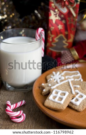 Christmas gingerbread cookies with a glass of milk and candy