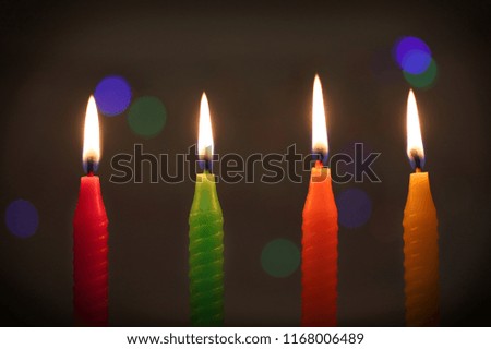 Burning candles with shallow depth of field on dark background 