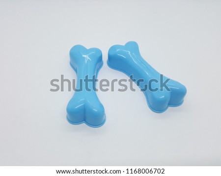 Bones made of blue plastic, white background