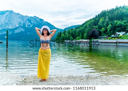 Lady in yellow Pareo in Mountain lake