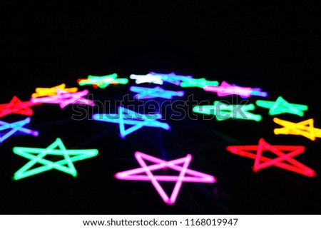 scenery view of far away blurry vision lighting on star symbol from outdoor carnival at night so impressive signage pattern for awesome abstract background