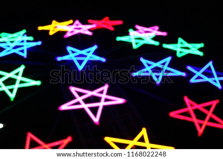 scenery view of far away blurry vision lighting on star symbol from outdoor carnival at night so impressive signage pattern for awesome abstract background