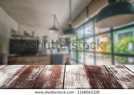 wood table on blur background in the cafe or coffee shop background with bokeh image - can use for display or montage your products