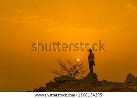 Photographer enjoying sunset view from Al hada mountain Taif, Saudi arabia
