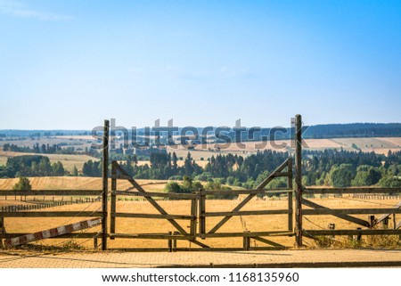 Wooden gate at a ranch in a beautiful rural landscape
