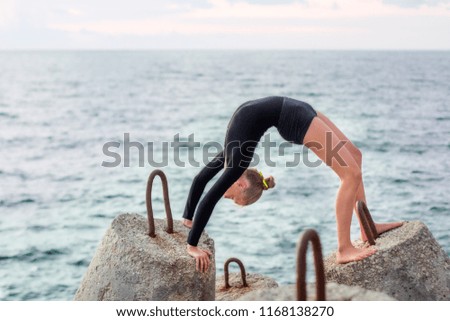 Gymnast girl on the background of the sea