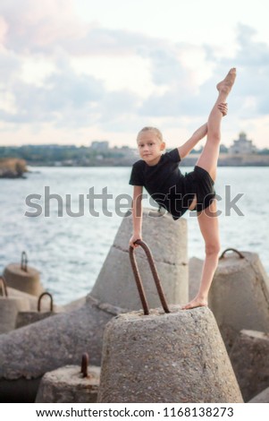 Gymnast girl on the background of the sea