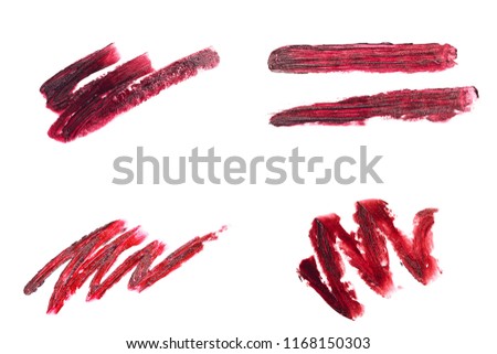 Collection of curves made with red lipstick. Beautiful textured strokes isolated on white. Cosmetics concept.