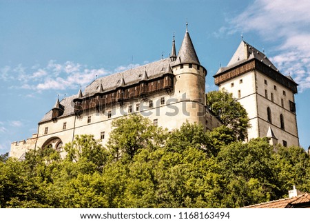 Large gothic castle Karlstejn in Czech republic. Ancient architecture. Travel destination. Yellow photo filter.