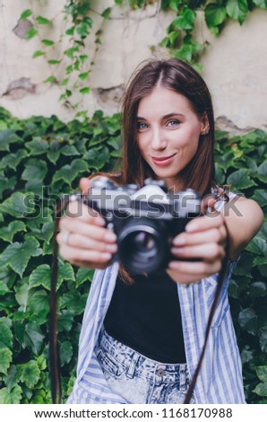 Pretty young woman with camera