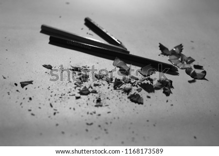 black and white photo of three pencils