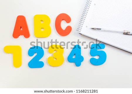 education in primary school. a layout of ABC letters, a notebook and markers on a white background. The beginning of the school year. Free space for text
